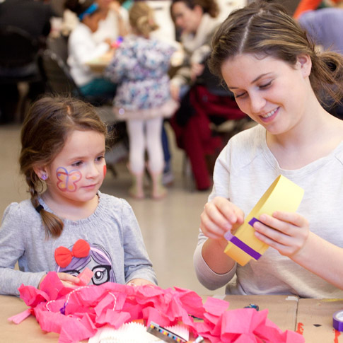 woman doing crafts with child